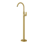 A modern matte gold floor-mounted faucet with a curved gooseneck spout and a single lever handle, shown against a solid light gray background.
