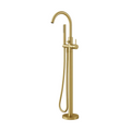 A modern high-arc freestanding bathroom faucet in a brushed gold finish, featuring a hand shower with a flexible hose, set against a solid light gray background.